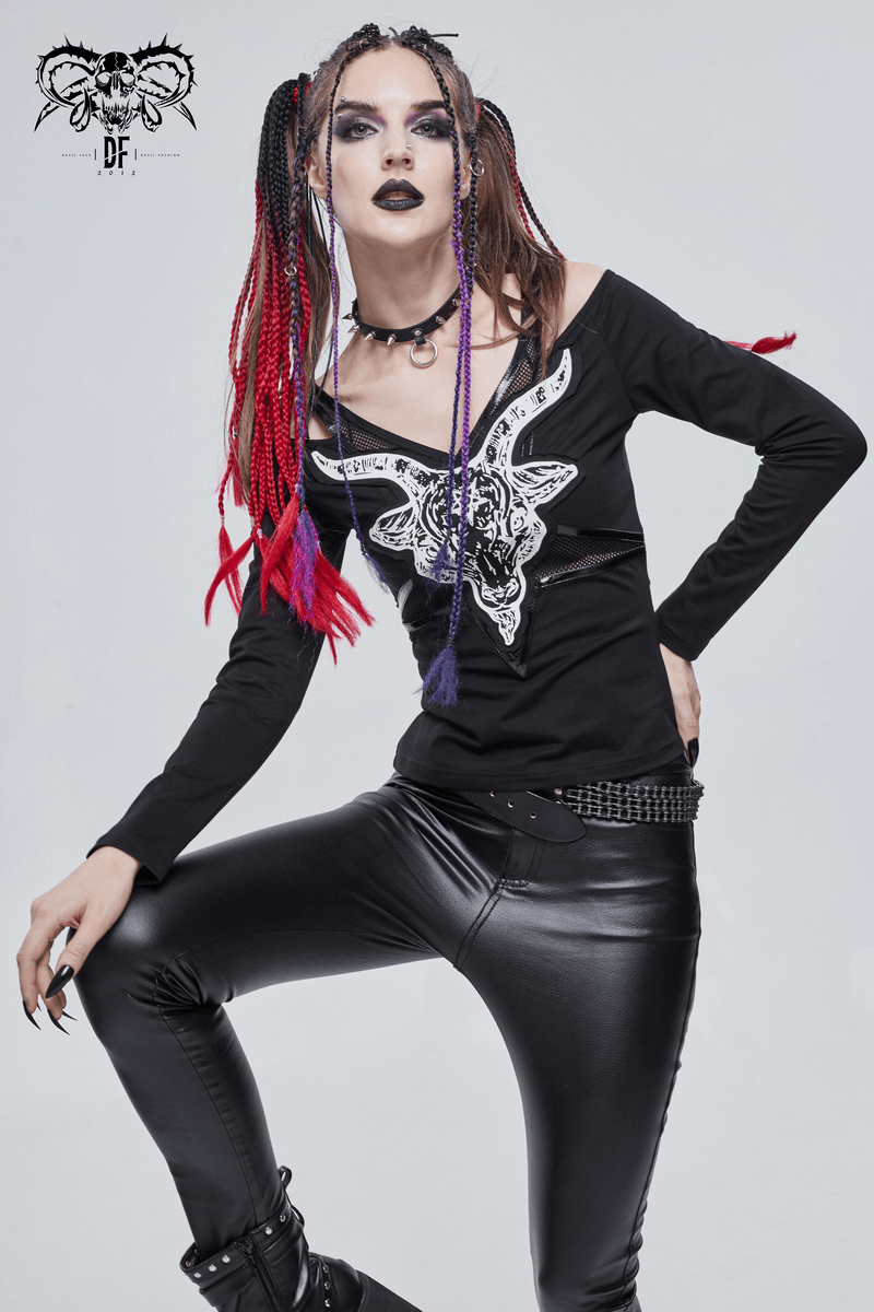 Gothic style black long sleeve top with goat skull design, stylish cutout shoulders, worn with black faux leather pants.