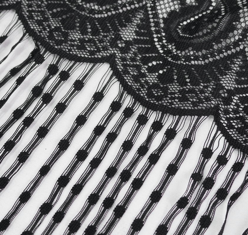 Close-up of elegant black lace detail with tassels, showcasing gothic style for women's capes and accessories.