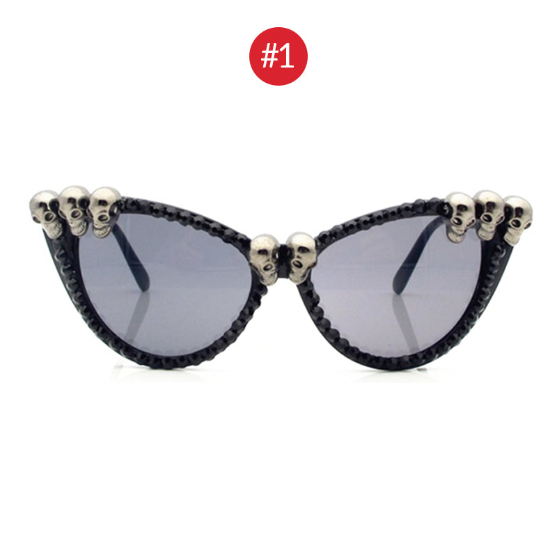 Stylish women's black skull rhinestone cat-eye sunglasses with decorative skull beads.
