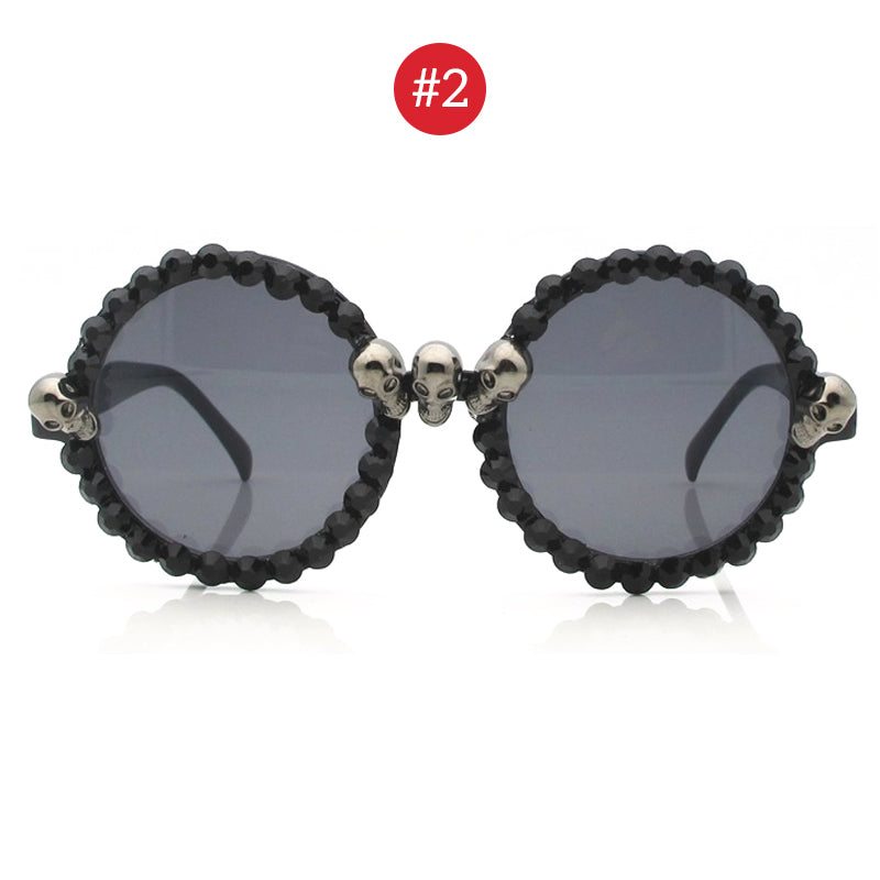 Gorgeous women's cat eye sunglasses with black rhinestones and skull accents for a goth-inspired look.