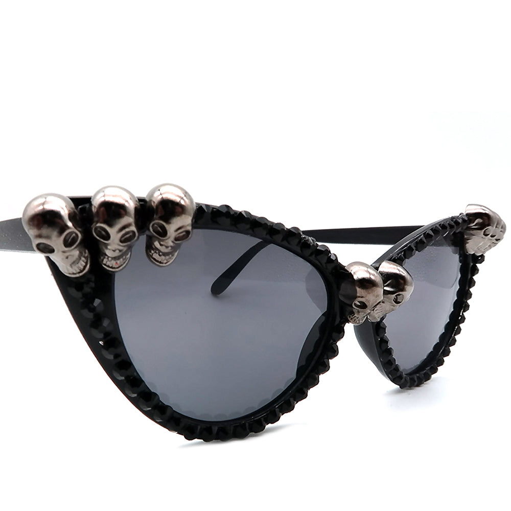 Gorgeous women's black skull rhinestone sunglasses with cat-eye frame and gothic style, perfect for non-conventional fashion lovers.