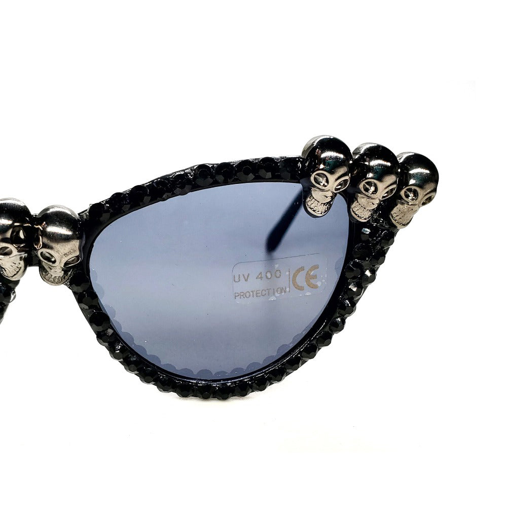 Gorgeous women's black skull rhinestone sunglasses with cat-eye frame and unique skull decorations.