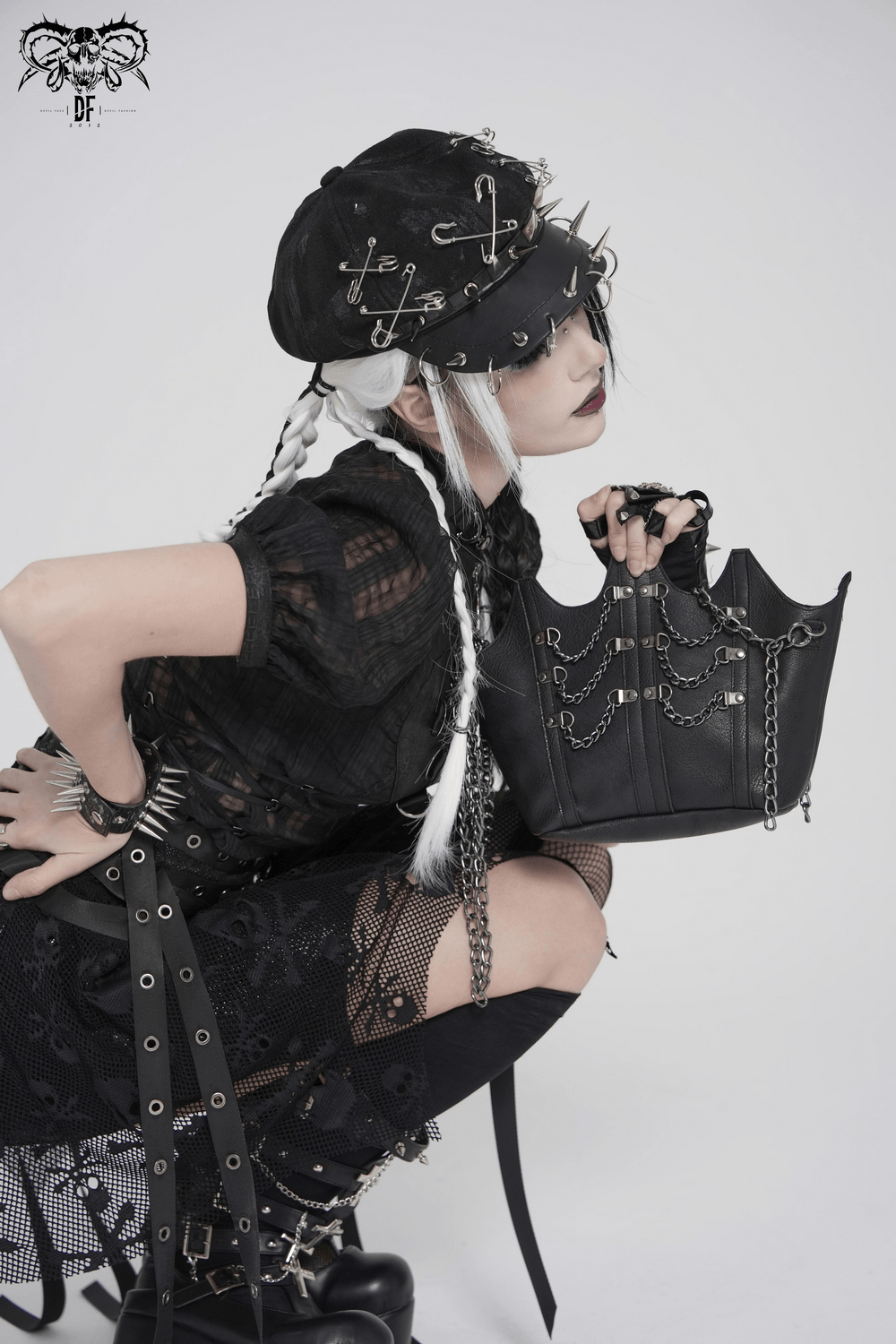 Goth Chain Shoulder Bag with Crown Silhouette Design worn by model in edgy black outfit with accessories.