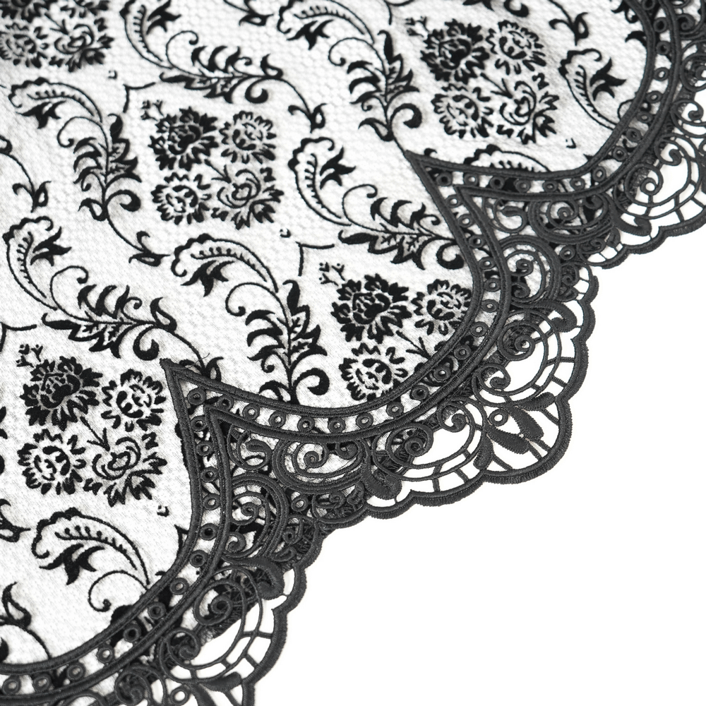 Intricate black and white lace overlay with floral patterns and scalloped edges, perfect for gothic and alternative fashion.