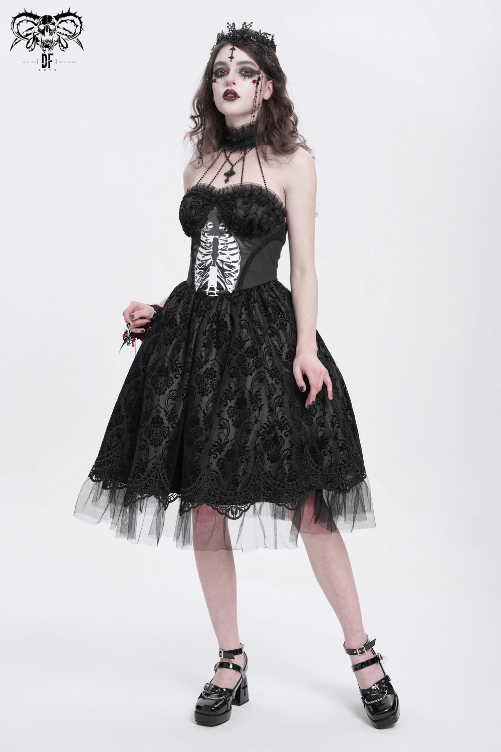 Goth halter dress with lace overlay, tulle skirt, and ribcage print, perfect for alternative fashion and Halloween events.