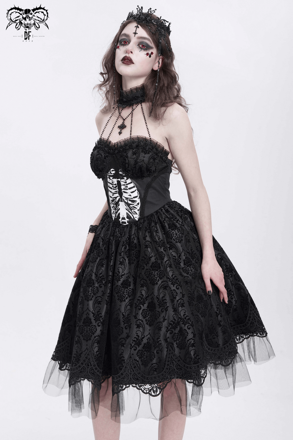 Gothic halter dress with lace overlay, tulle skirt, and ribcage print, perfect for alternative fashion or Halloween.