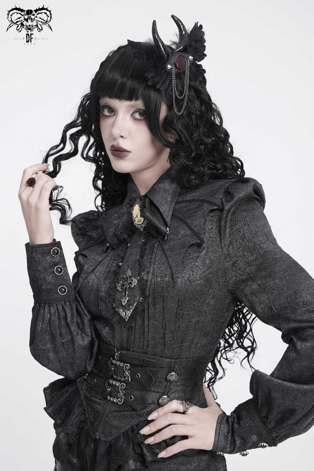 Goth Horn and Feather Brooch with Chain Accents featured on a model in gothic attire.