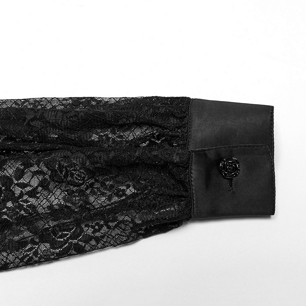 Close-up of the sleeve of a black gothic lace blouse featuring a rose button and delicate lace detailing.