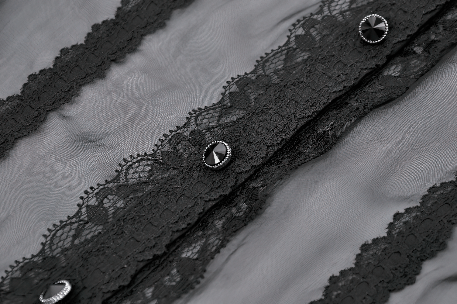 Goth Lace-Trimmed Puff Sleeved Blouse with Button Detail featuring black sheer fabric and intricate lace ruffles.