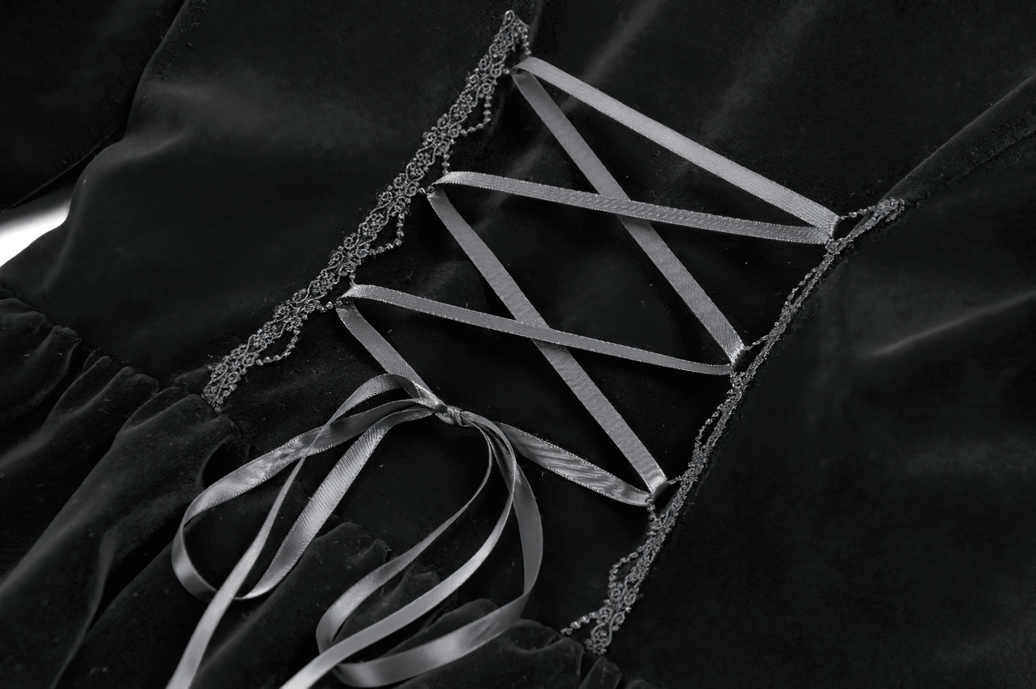 Close-up of the lace-up detail of the Goth Lace-Up Tiered High-Low Jacket with Bell Sleeves showcasing intricate lace and ribbons.