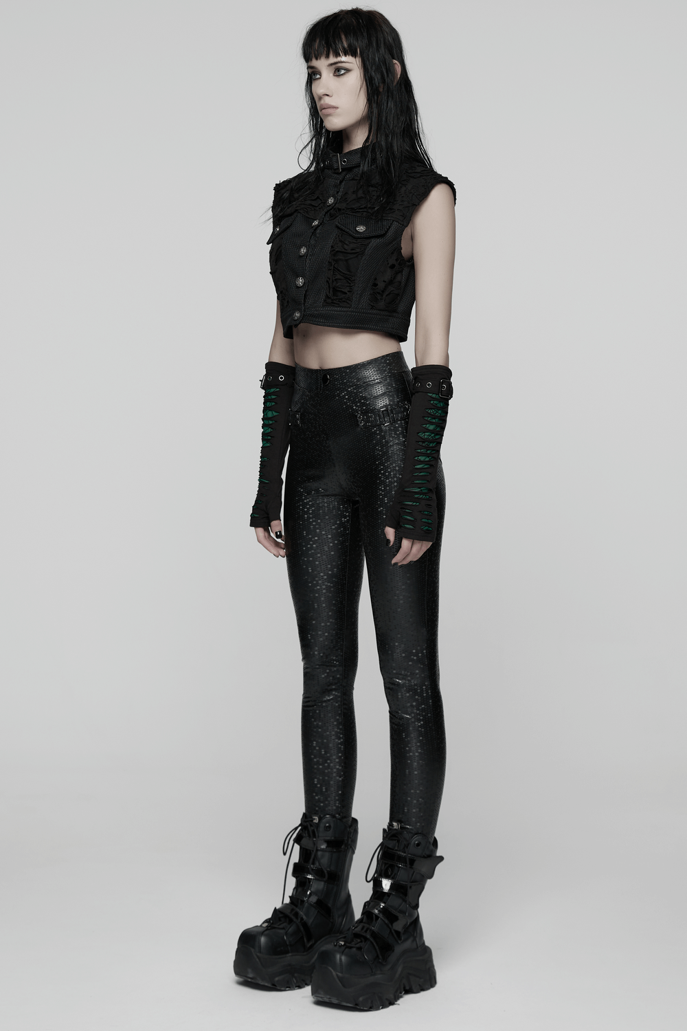 Goth Leggings with Stretch Fabric and Buckle Straps Pockets paired with a cropped black vest and bold platform boots.