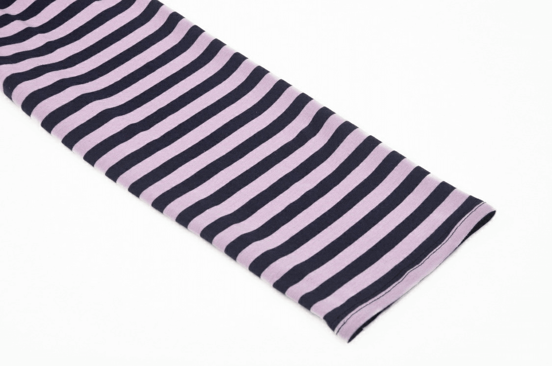 Close-up of black and violet striped long sleeve fabric for a goth crop top, perfect for edgy streetwear.