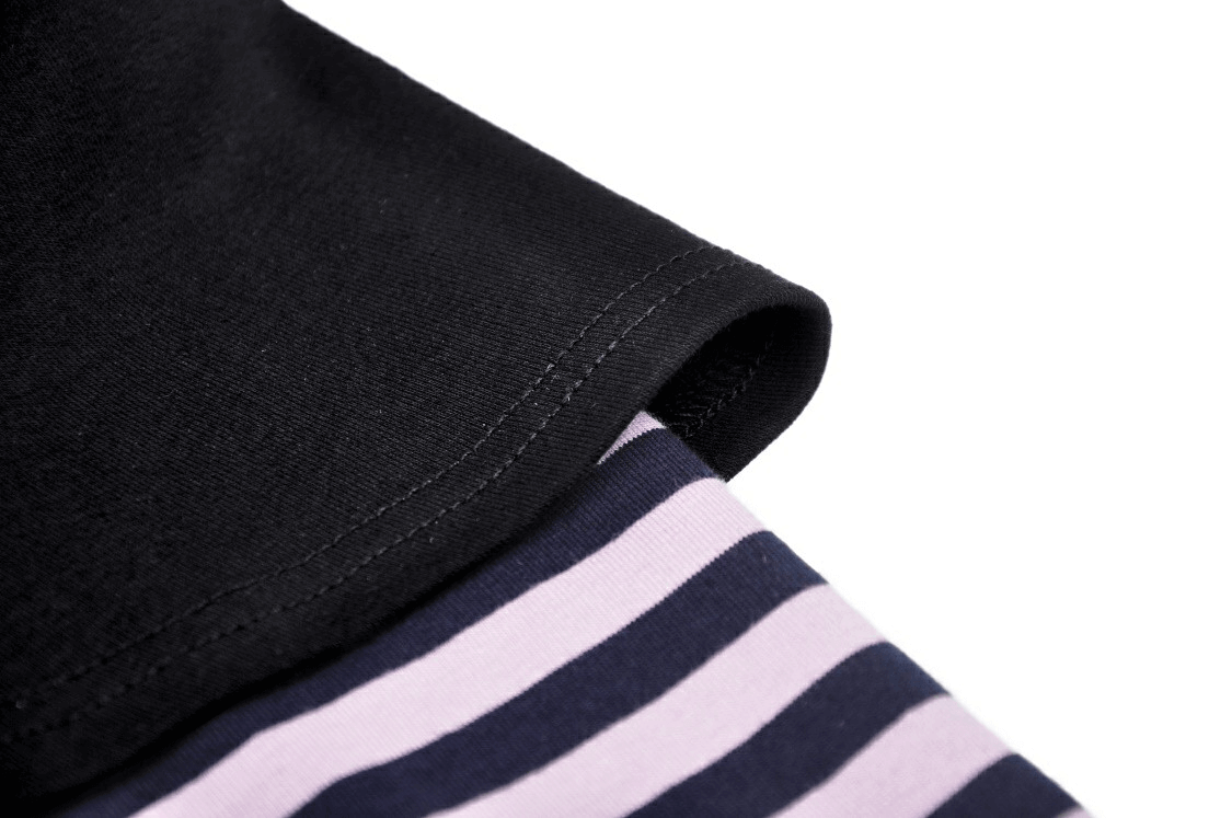 Close-up of goth punk crop top's black cuff and striped sleeve, showcasing dark fashion and playful style.