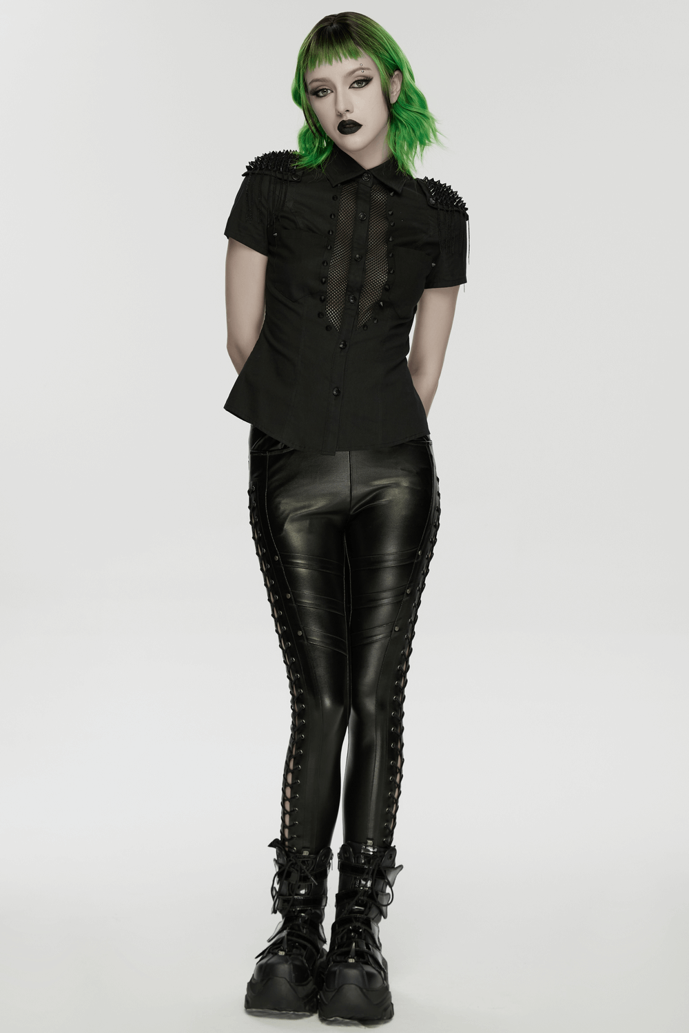 Goth Punk Mesh Panel Spiked Shoulder Button Shirt worn with leather pants and combat boots, showcasing edgy punk style.