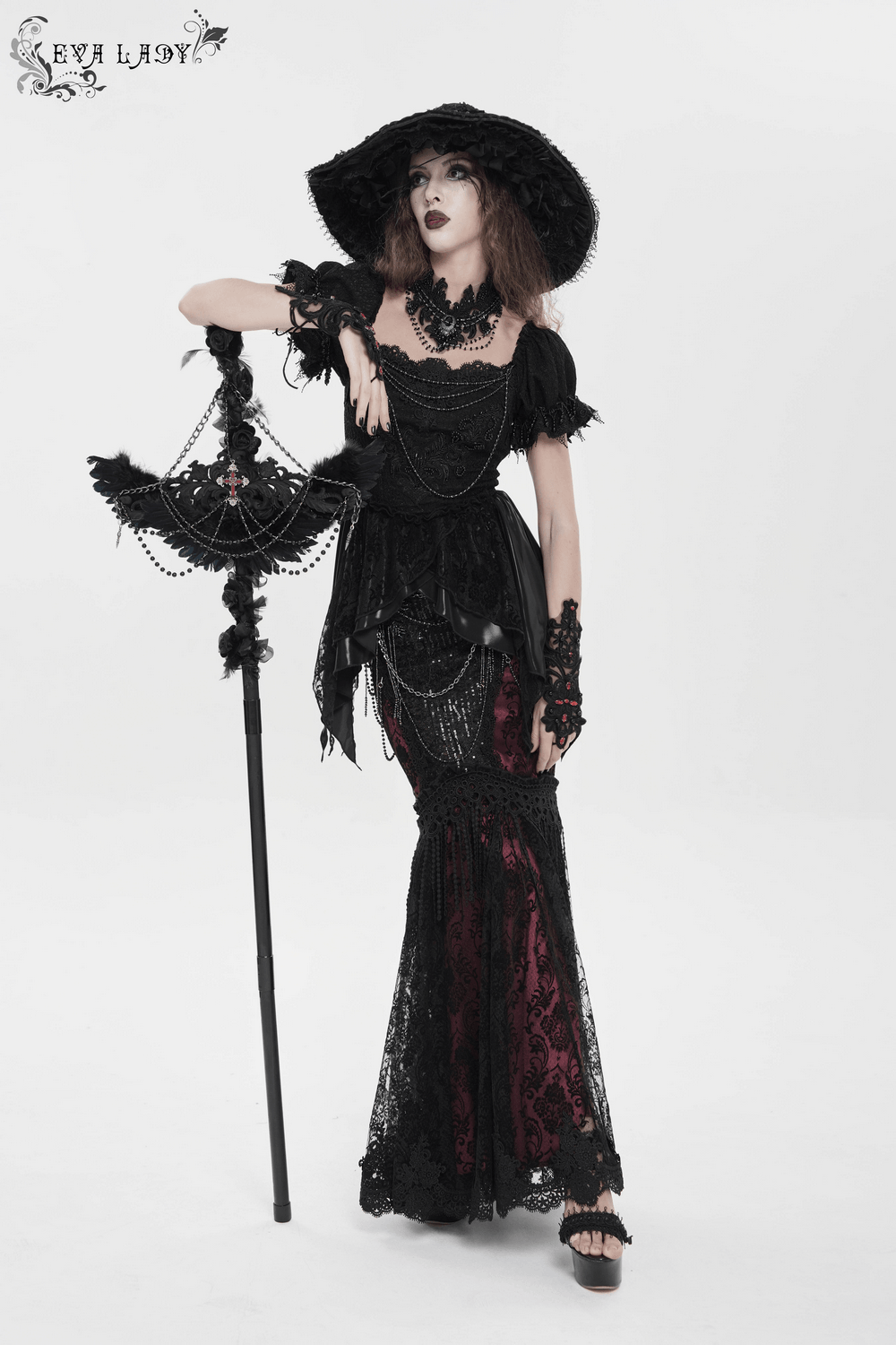 Alt Tag: Goth Raven Cross Staff with Roses and Beaded Chains held by gothic model in black lace dress, raven wings, rose accents and beaded chains