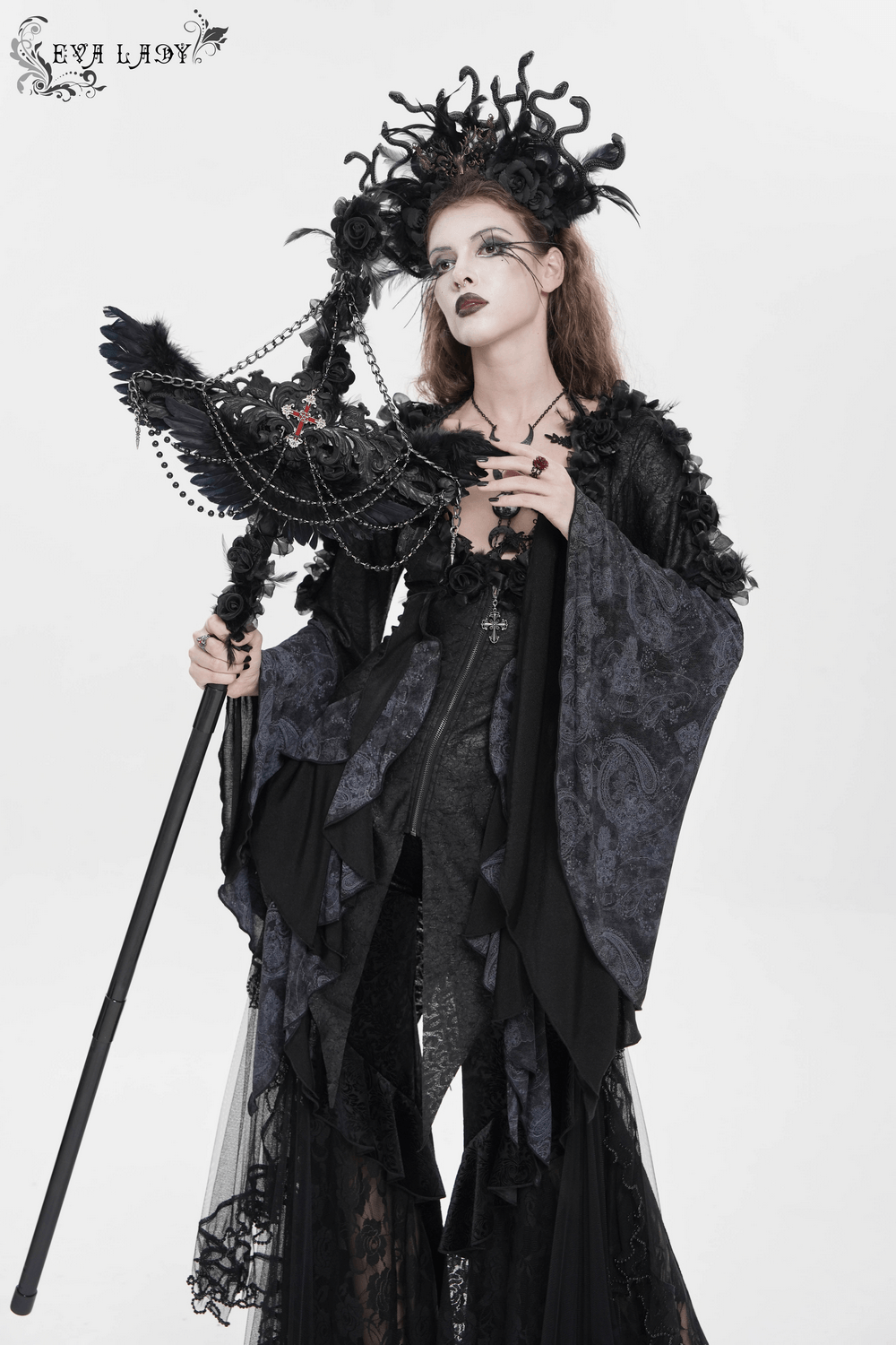 Alt Tag: Goth Raven Cross Staff with Roses and Beaded Chains held by gothic woman in black lace dress, raven wings, roses, beaded chains prop