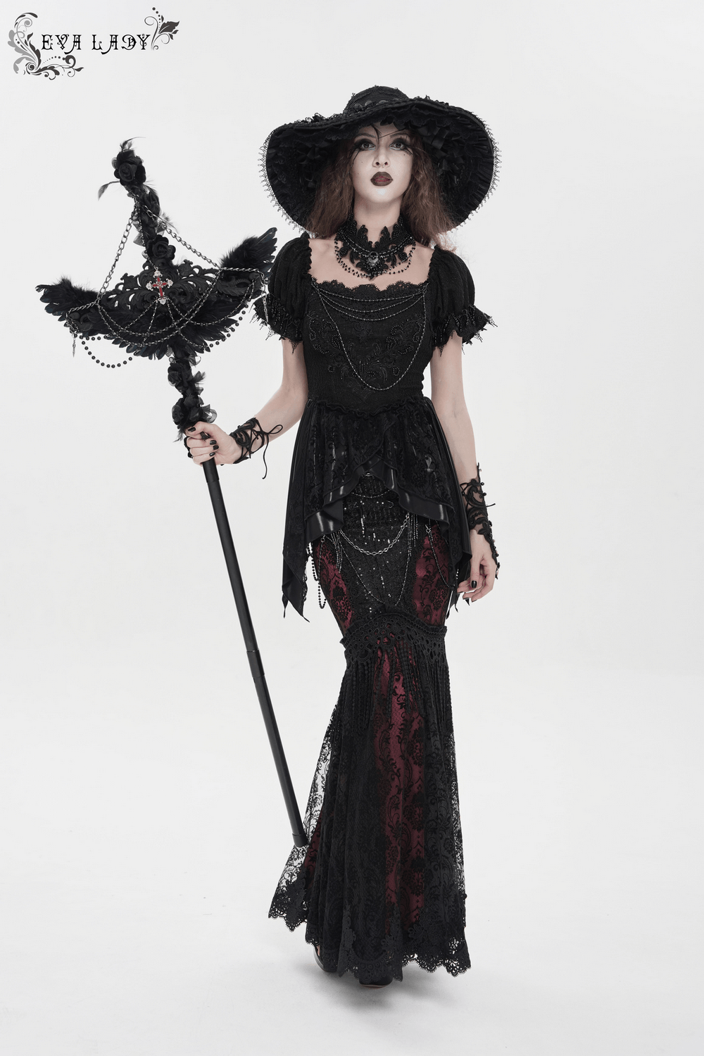 Alt Tag: Goth Raven Cross Staff with Roses and Beaded Chains held by model in black gothic dress and wide-brim hat, beaded chains and roses