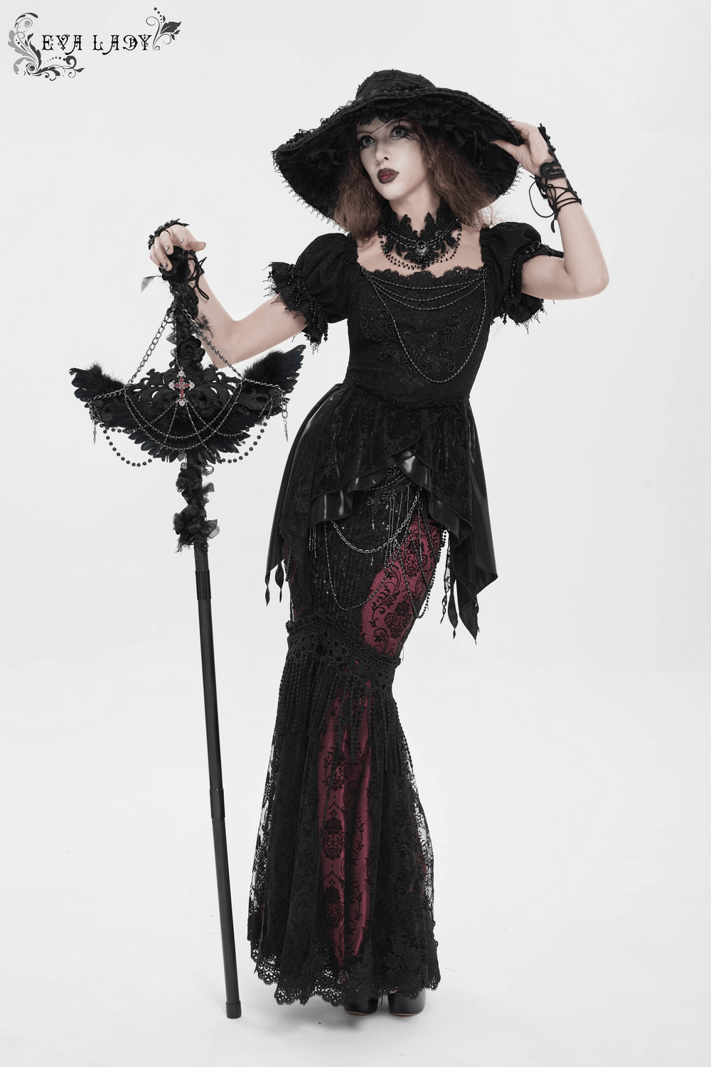 Alt Tag: Goth Raven Cross Staff with Roses and Beaded Chains held by model in black gothic dress, beaded chains and rose accents for dark fantasy styling
