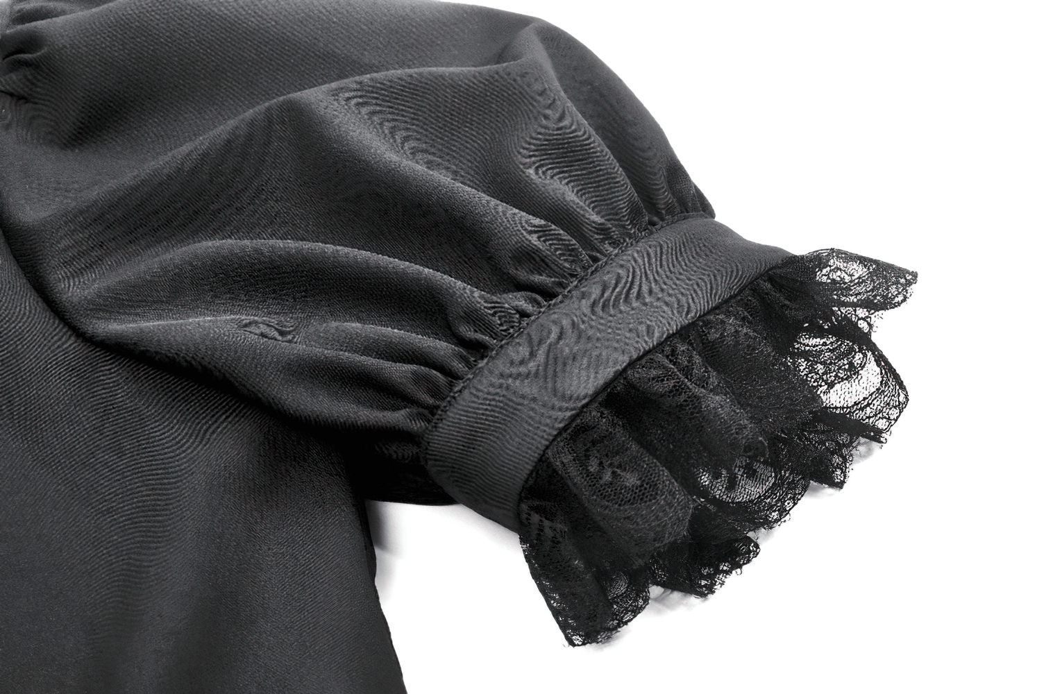 Close-up of a black satin blouse sleeve with lace trim and ruffle details, showcasing gothic elegance.