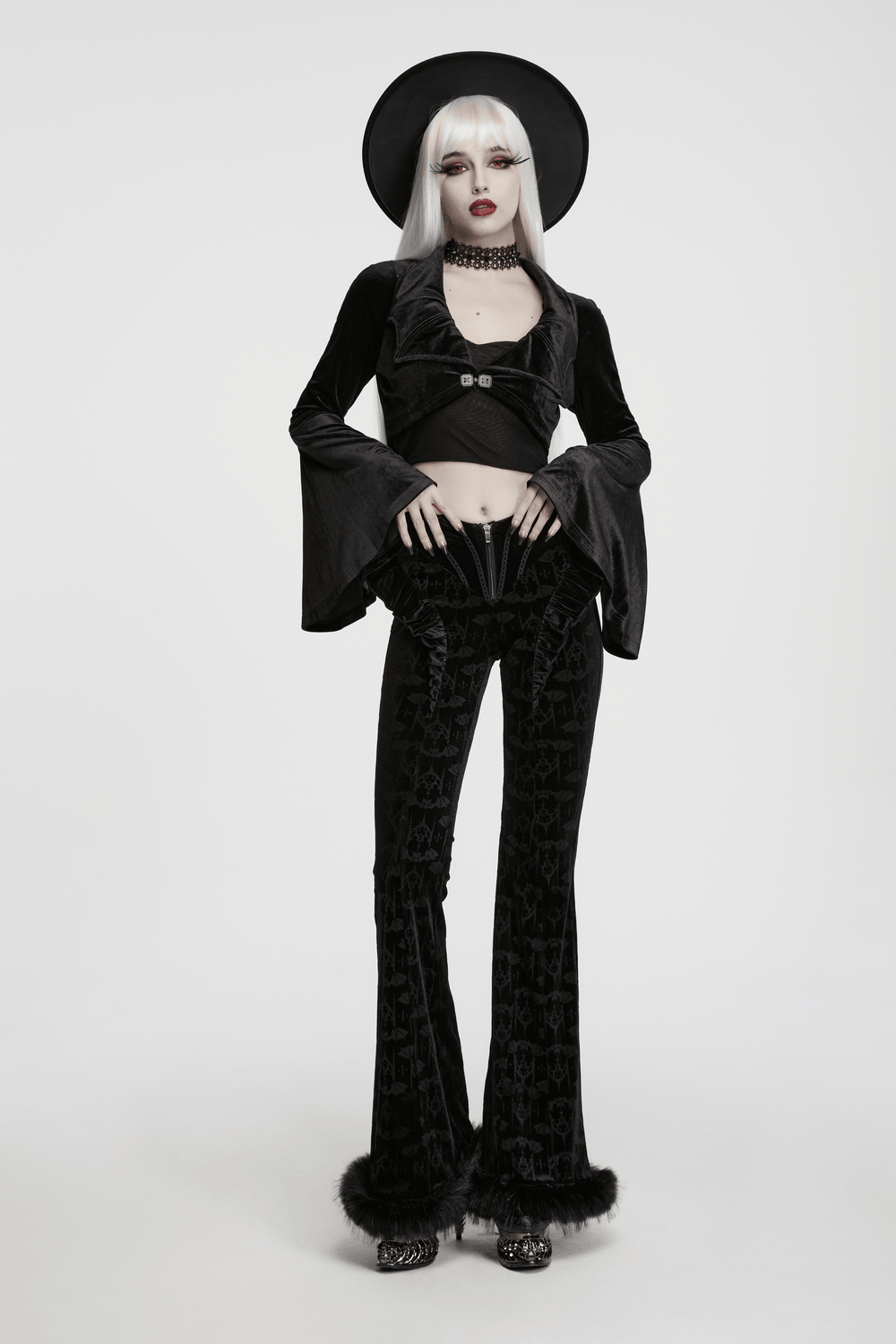 Goth Velvet Bolero with Bat Collar and Bell Sleeves worn with stylish black flared pants for a gothic fashion look.