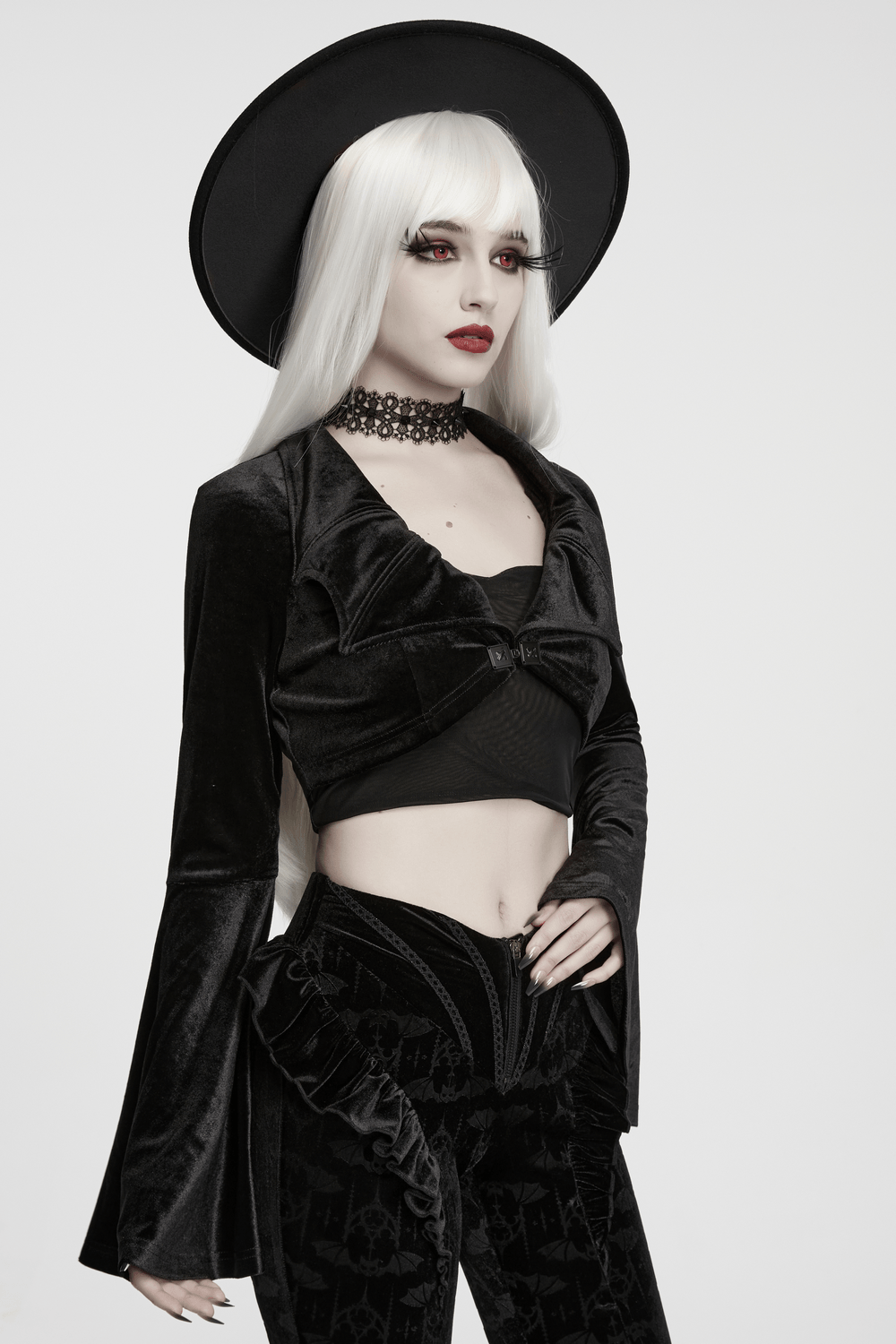 Goth Velvet Bolero with Bat Collar and Bell Sleeves styled with flared sleeves and a chic black hat.