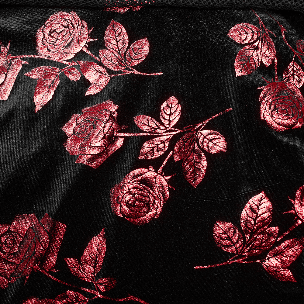 Close-up of black velvet fabric featuring intricate red rose and leaf print design.