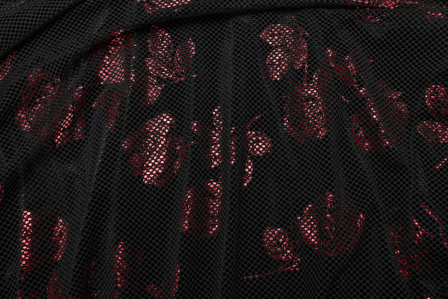 Detail of goth velvet rose print fabric with striking black mesh overlay and deep red floral pattern.