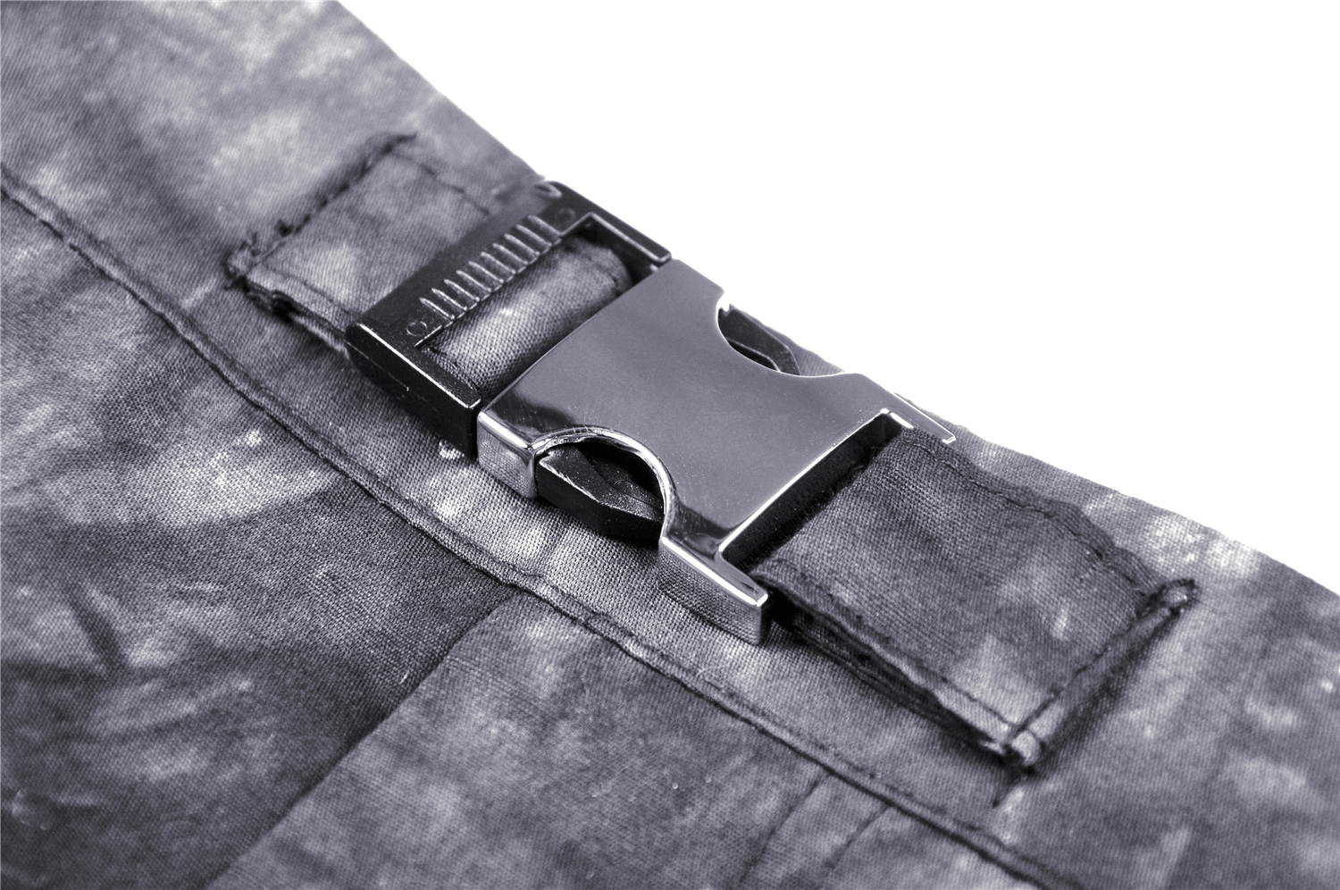 Close-up of the buckle detail on a black tie-dye goth mini skirt with ruffles and chains.