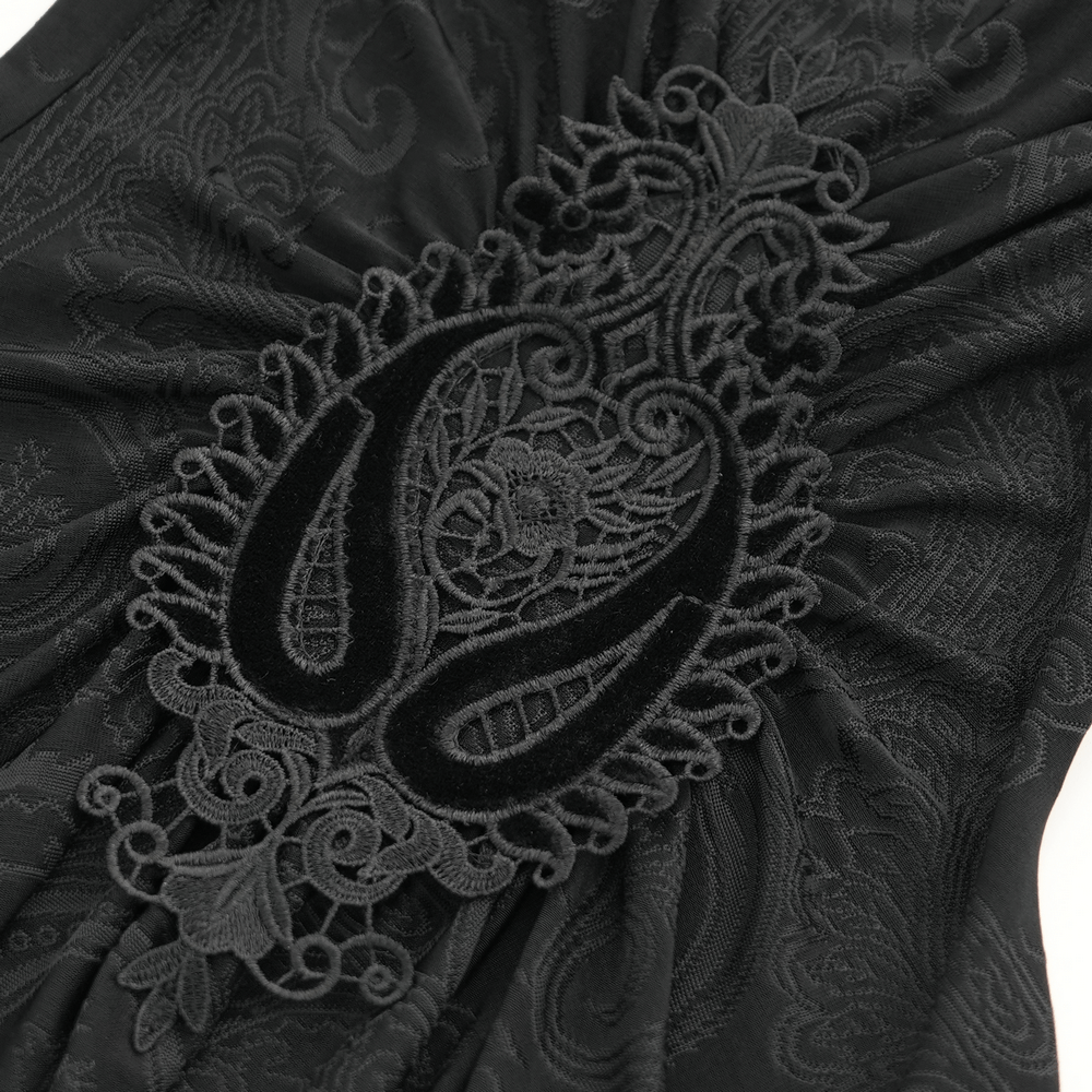 Close-up of intricate paisley lace detail on a gothic women's top, showcasing dark elegance and Victorian style.