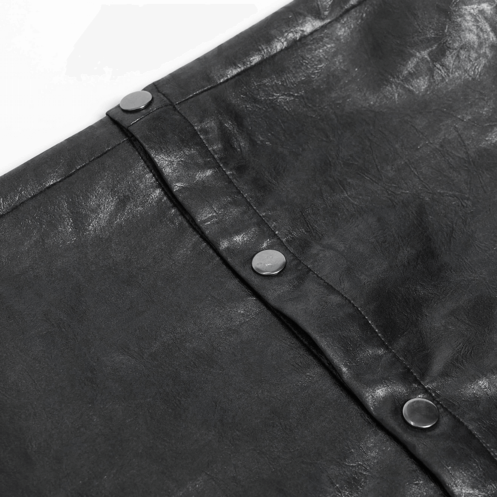 Close-up of goth zip pants with detachable chains and wide legs showcasing the shiny metal buttons and textured fabric.