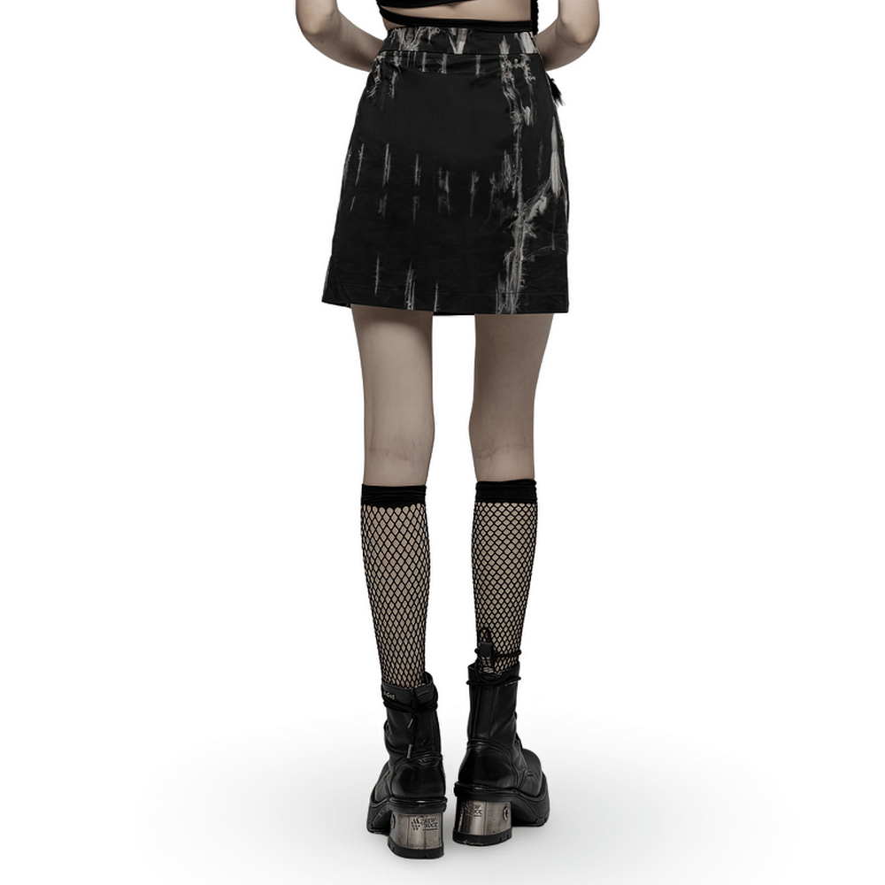 Back view of a chic Gothic A-Line skirt with tie-dye pattern, side slit, paired with fishnet stockings and edgy boots.