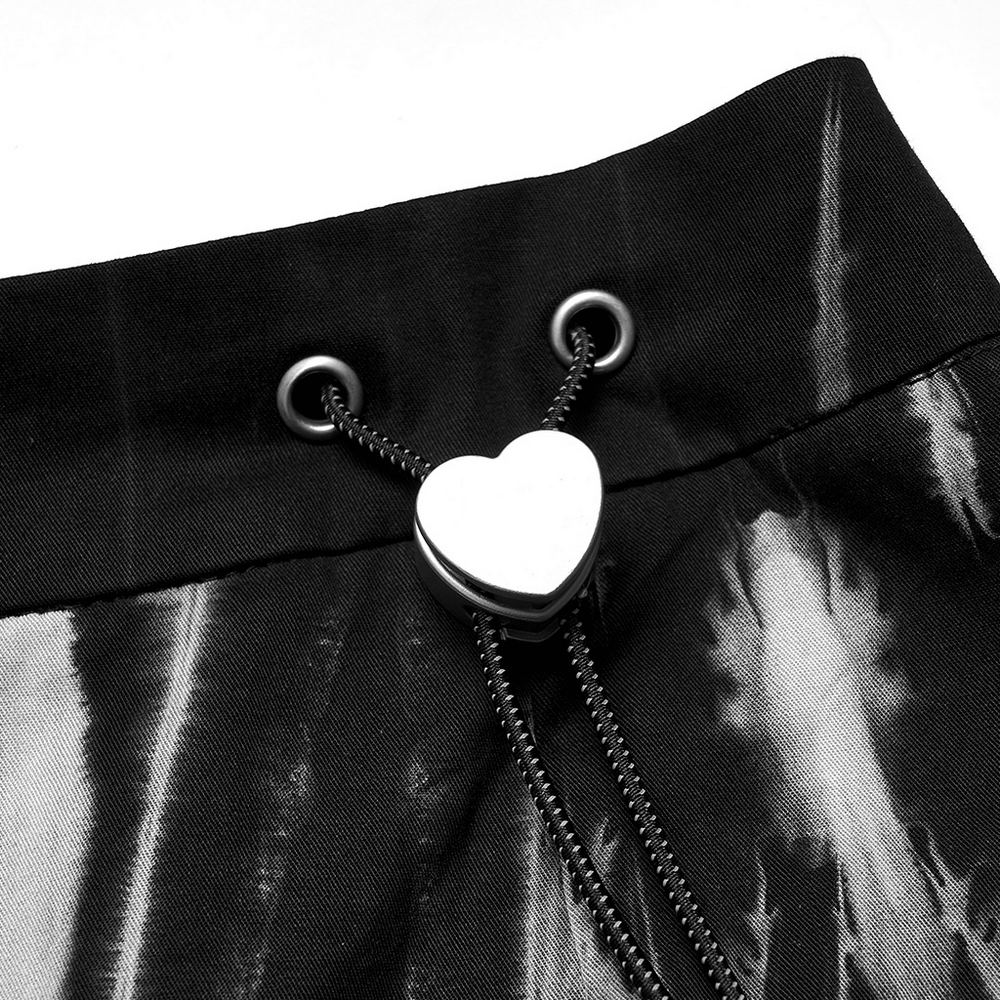 Close-up of heart buckle detail on Gothic A-Line skirt with tie-dye pattern and adjustable side ties.