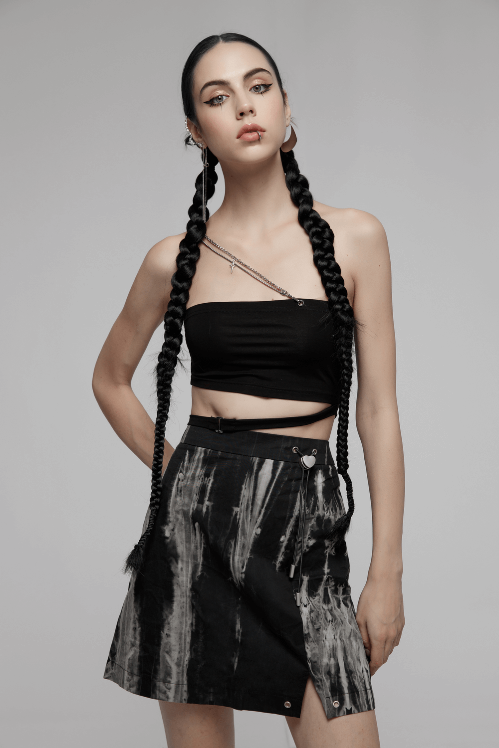 Model showcasing a chic Gothic tie-dyed A-line skirt with heart buckle and black crop top, emphasizing bold fashion style.