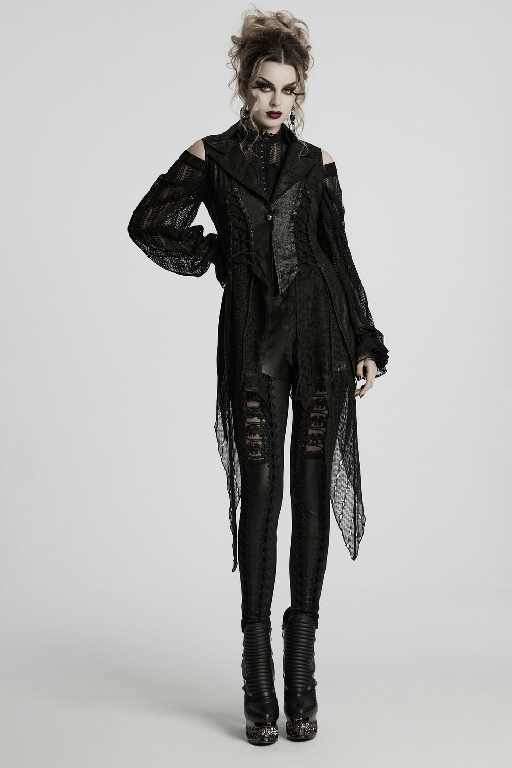 Gothic alien asymmetric cape in cracked leather with lace-up design and mesh, featuring a dramatic silhouette.
