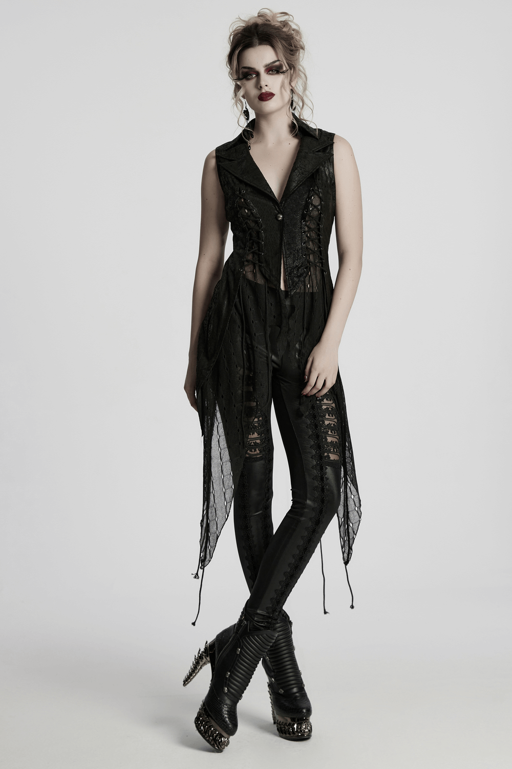 Gothic alien asymmetric cape in black with lace-up design, mesh details, and bold silhouette.
