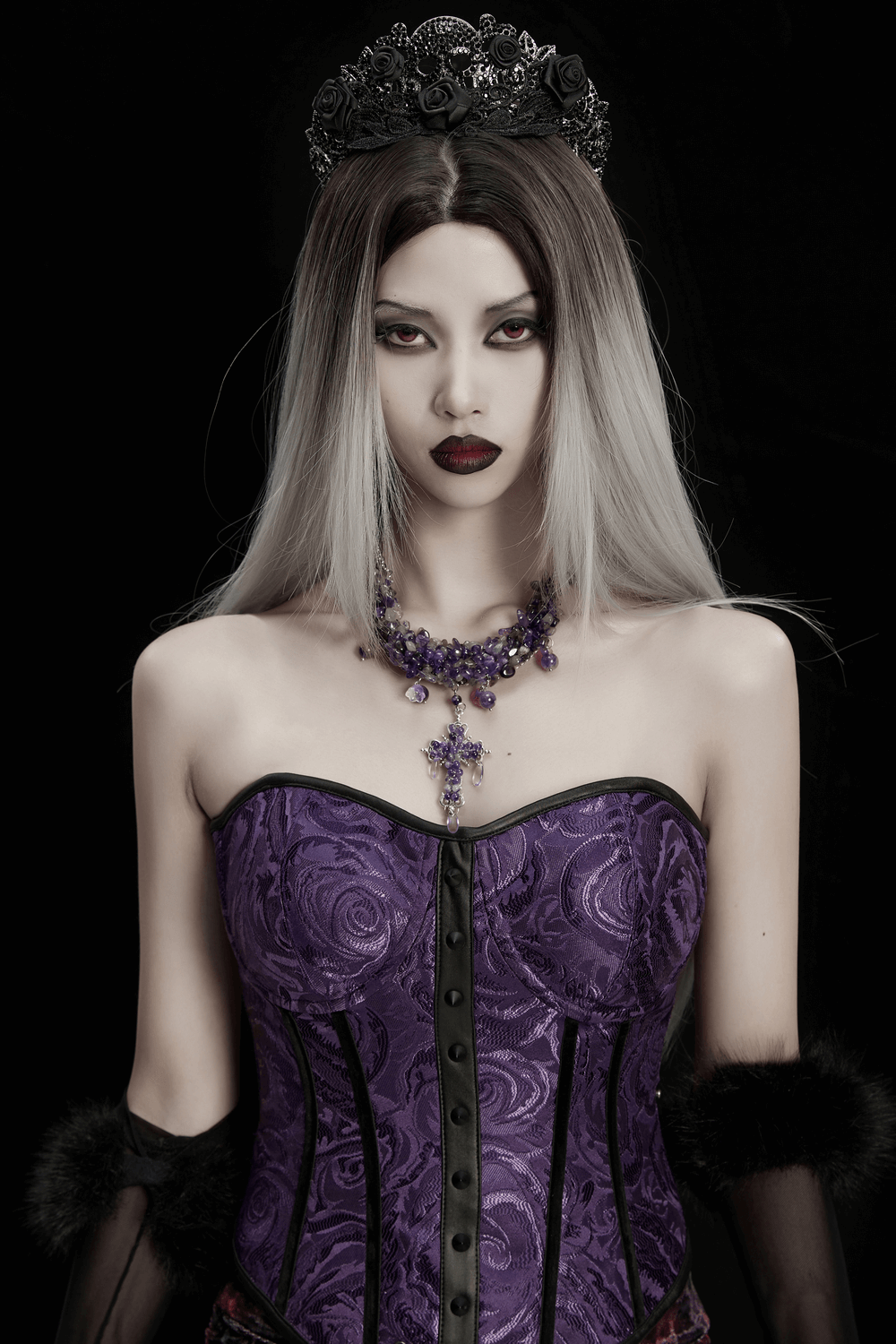 Gothic Amethyst Crystal Necklace with Cross Pendant worn by a model in goth style attire against a dark background.