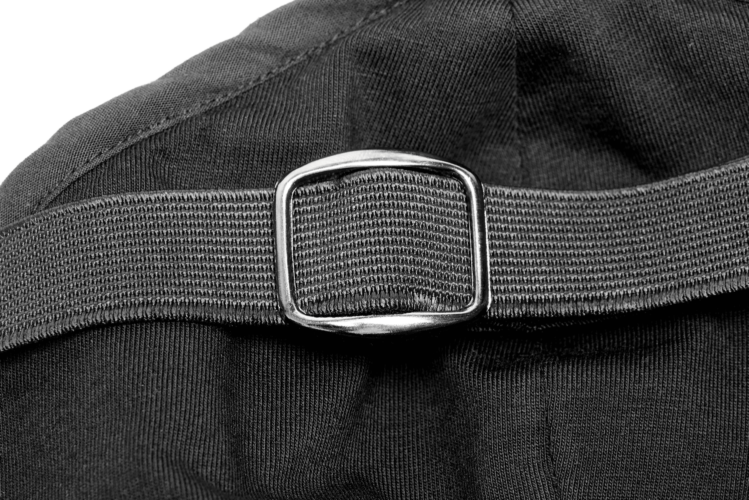 Close-up of a black adjustable strap buckle on a fabric surface, showcasing quality craftsmanship.