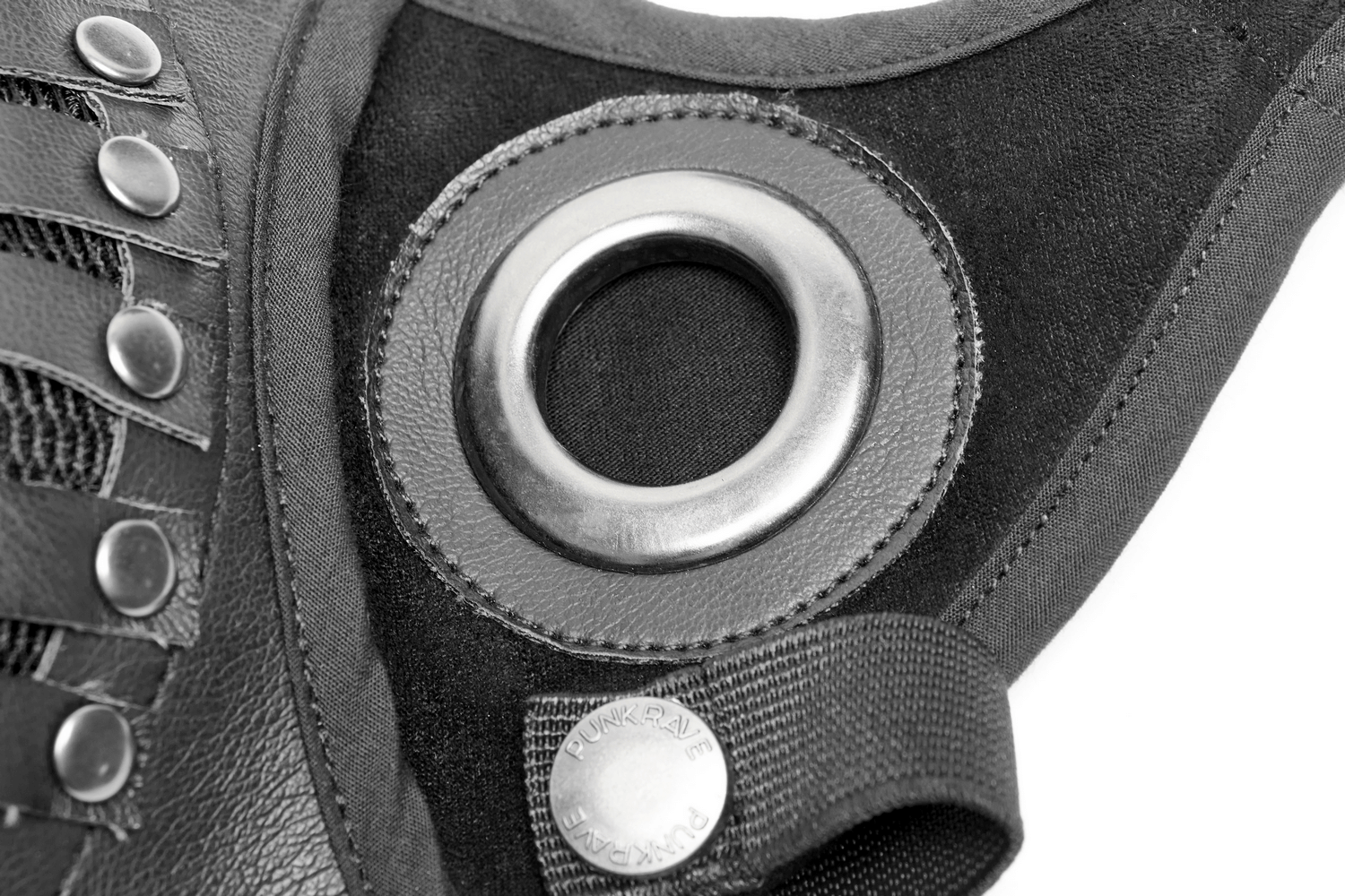 Close-up of a black adjustable leather mask featuring metal eyelet and lacing for a bold punk-goth aesthetic.