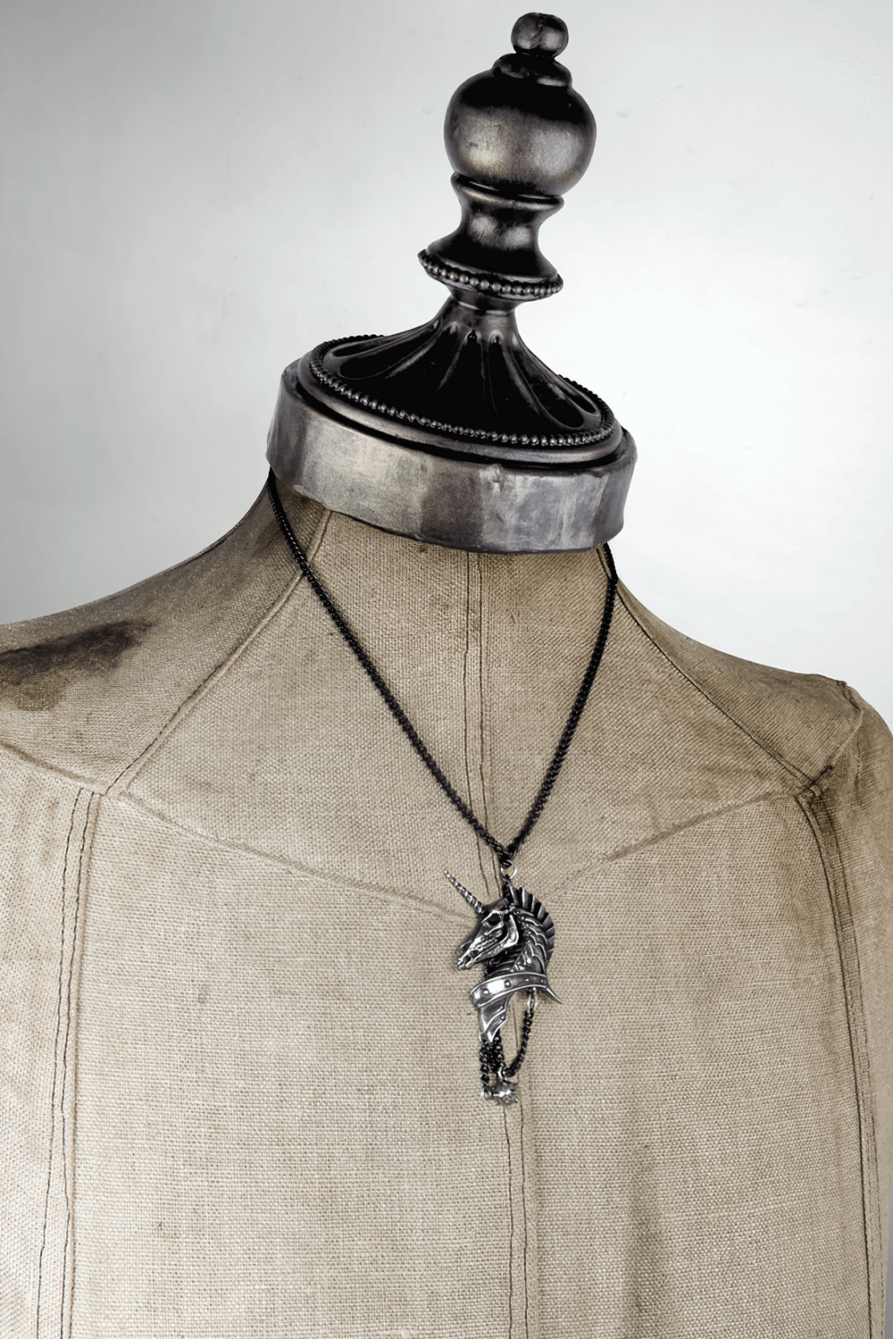 Gothic antiqued pewter skeletal unicorn head pendant on a black chain, showcasing dark elegance and mystique.