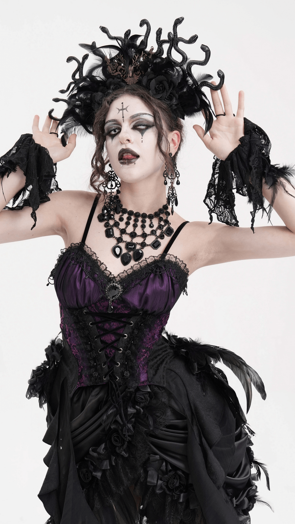 Medusa-inspired Gothic headpiece with black feathers and roses, worn at a cosplay event, exuding dark elegance.