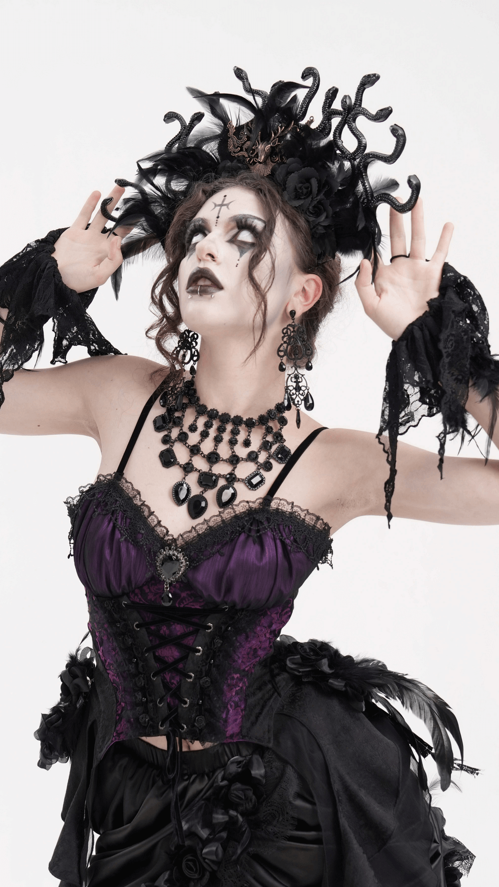 Gothic model in purple corset with Medusa-inspired headpiece and dark makeup, showcasing dark fantasy fashion.