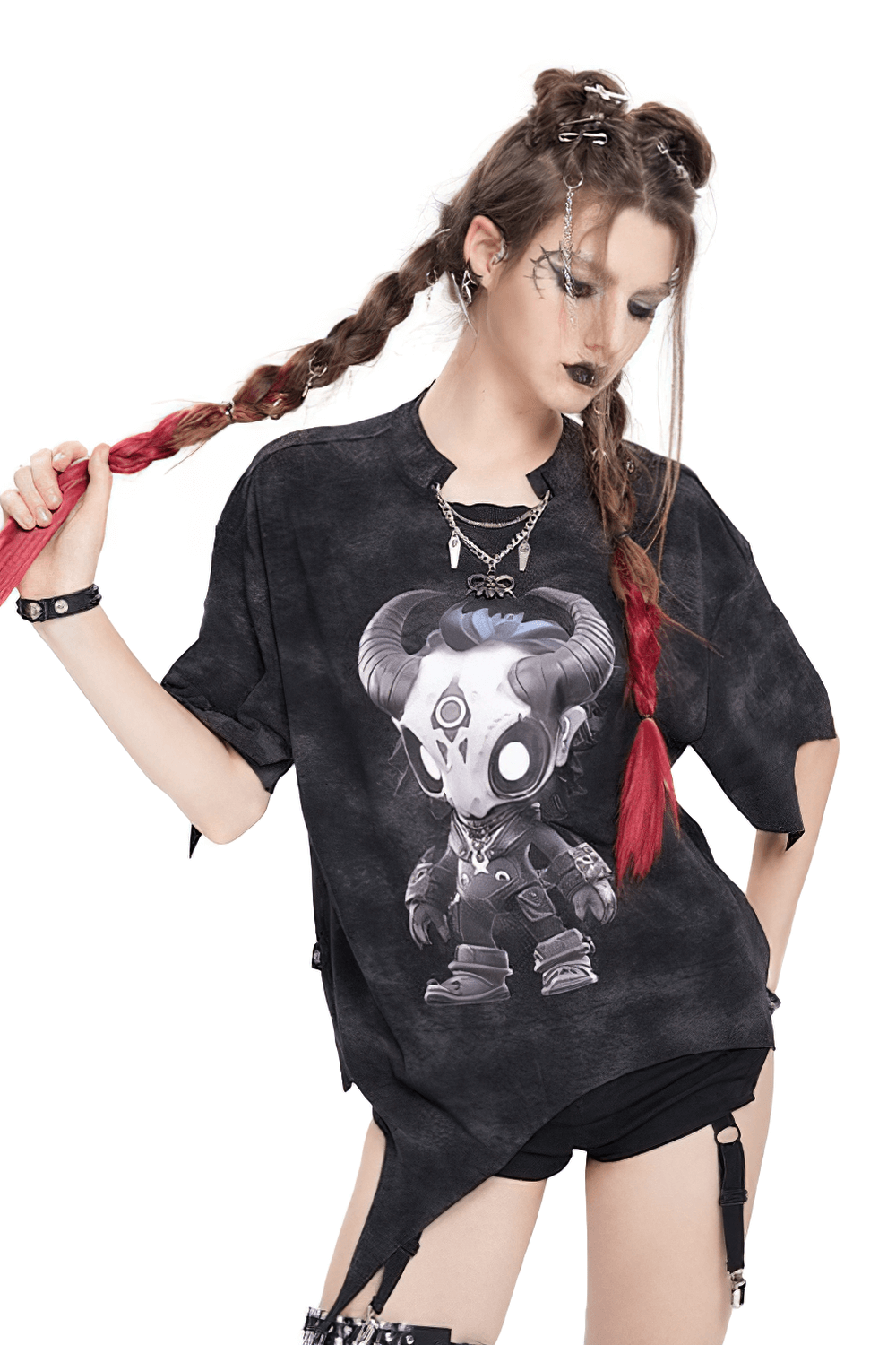 Gothic asymmetric skull cartoon graphic tee with distressed hem worn by model with edgy hairstyle.