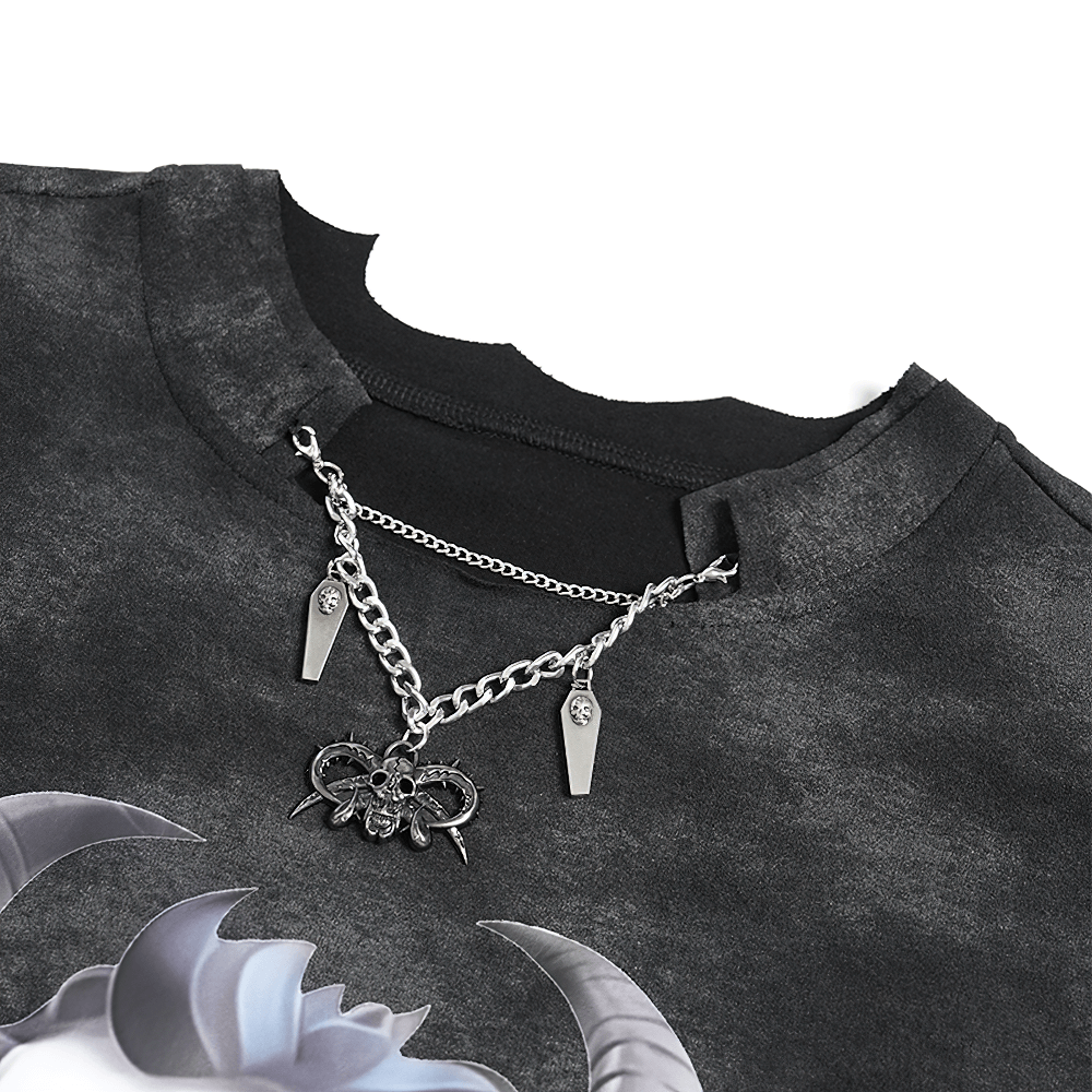 Close-up of gothic asymmetric t-shirt collar with silver chain and skull pendant, showcasing punk style and distressed fabric.