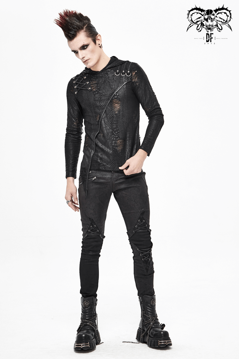 Punk-style model showcasing black asymmetrical hoodie and edgy attire with stylish boots.