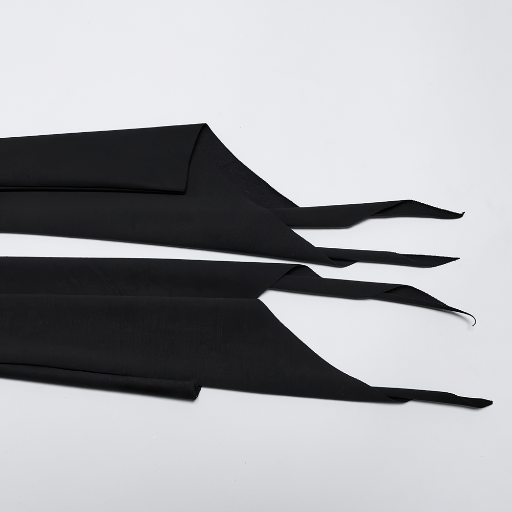 Three strips of black stretchy fabric with asymmetrical edges for crafting or fashion design.