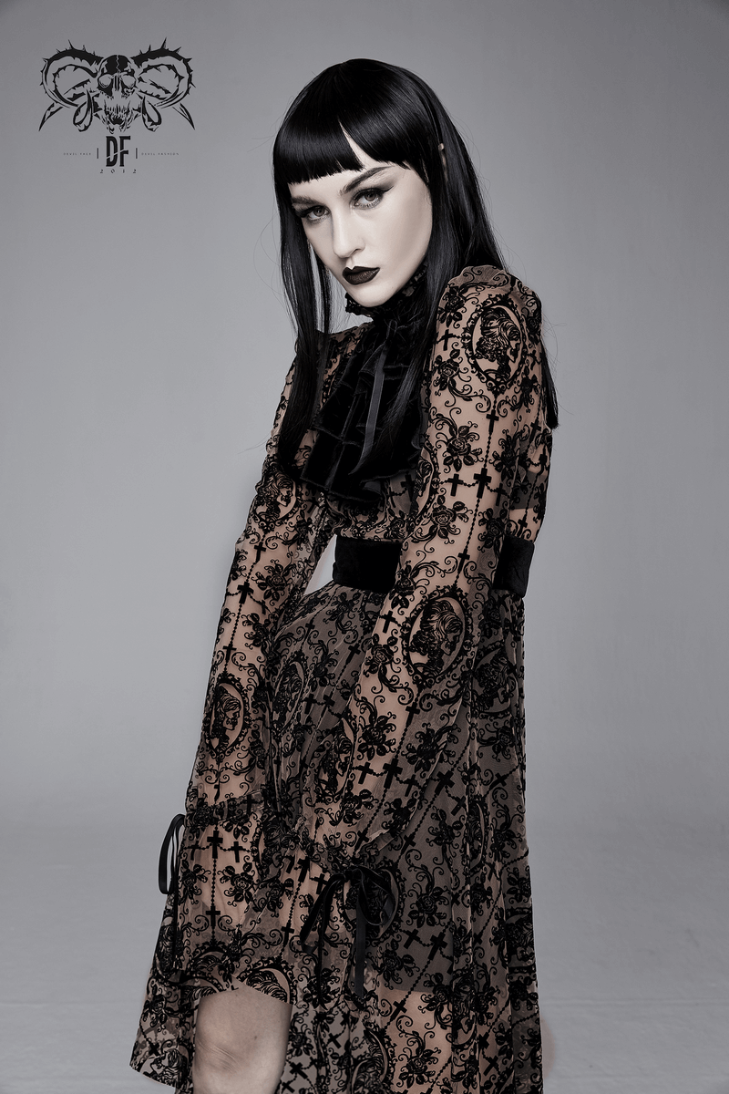 Women in a gothic lace dress with an asymmetrical cut, showcasing dark style and elegance against a minimalist backdrop.