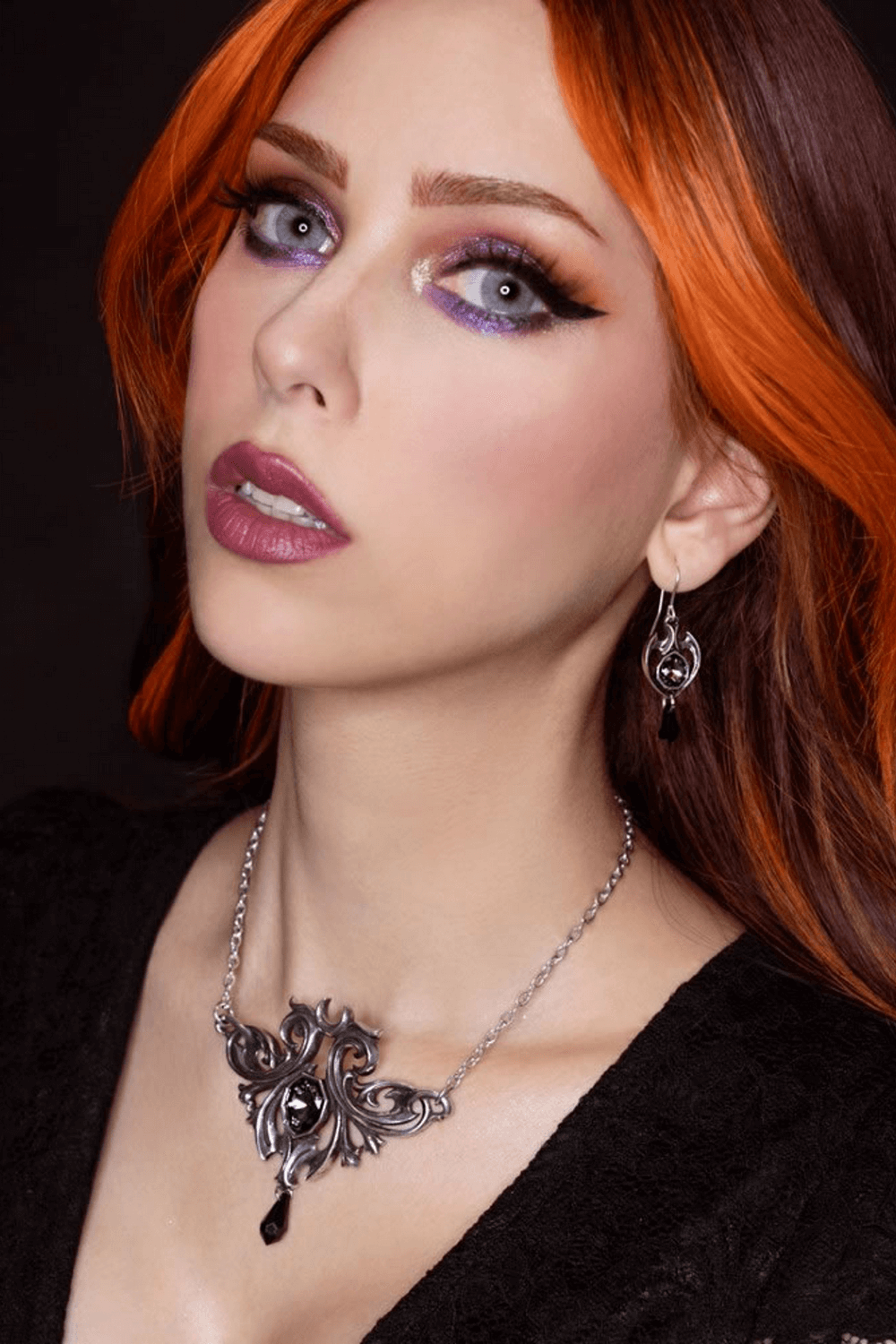 Gothic Baroque Midnight Memorial Drop Earrings worn by a model with striking makeup and orange hair.