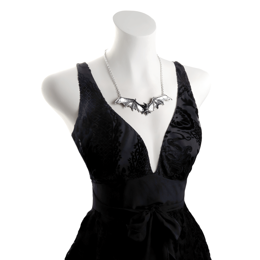 Gothic bat necklace with pewter wings displayed on a dress form, showcasing dark elegance and macabre style.