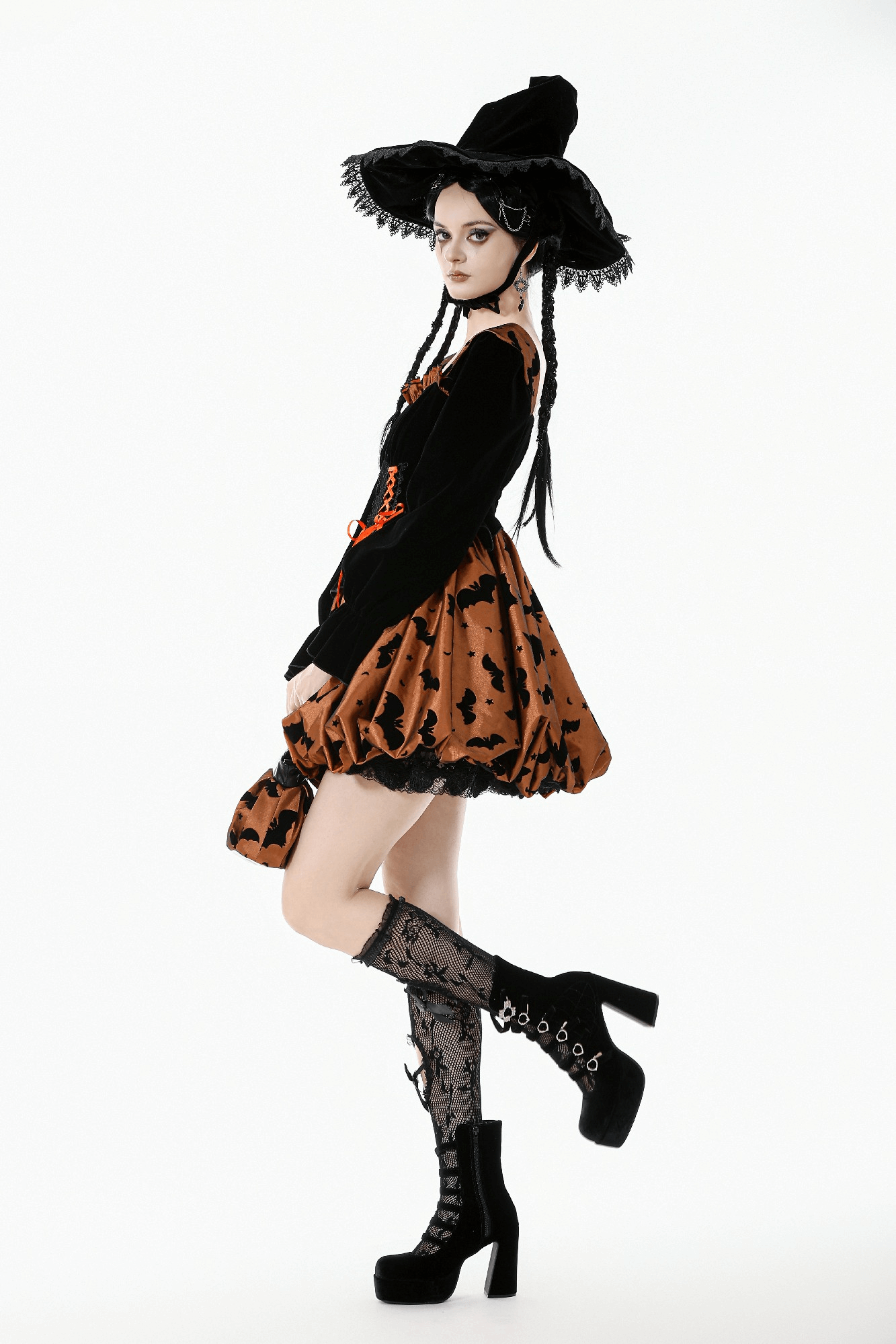 Gothic Bat Print Puff Sleeved Dress with Corset Lacing worn with a witch hat and stylish knee-high socks.