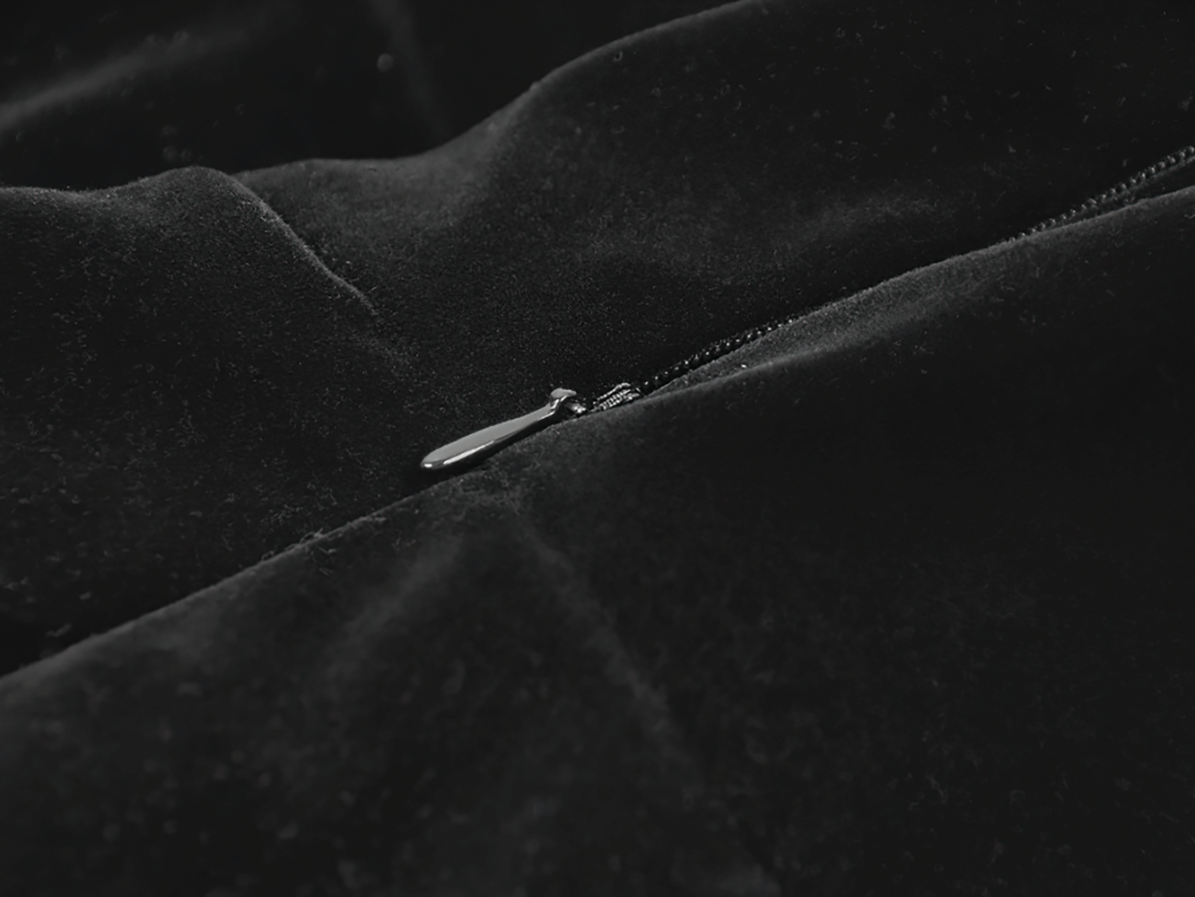 Close-up view of the zipper on the Gothic Bat Print Puff Sleeved Dress with Corset Lacing, showcasing luxurious black velvet texture.